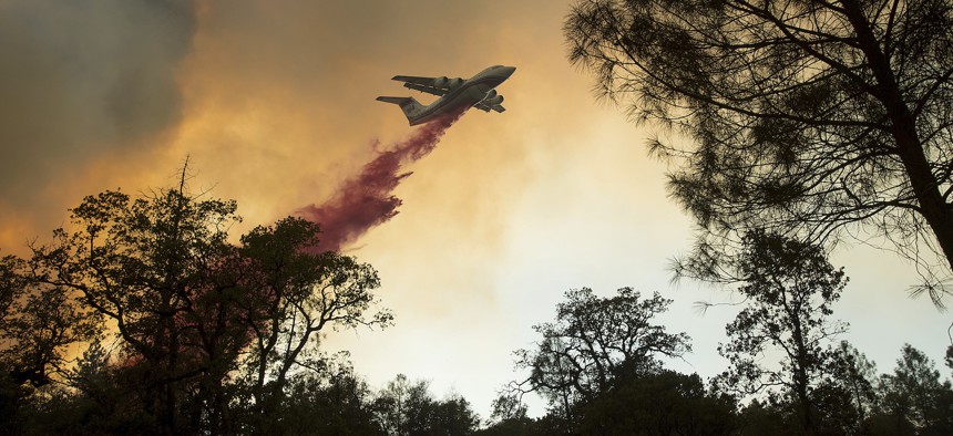 A plane drops retardant while battling a wildfire near Oroville, Calif., on Saturday, July 8, 2017. 