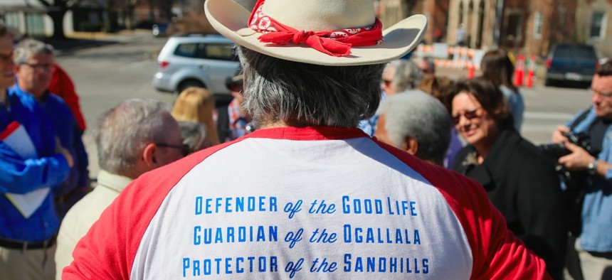 Anti-pipeline activist Allen Schreiber of Lincoln, Nebraska, wears a shirt inscribed with slogans opposing the Keystone XL pipeline during a rally outside the State Capitol.