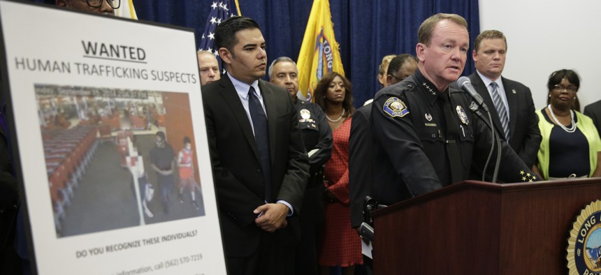 Long Beach Police Chief Jim McDonnell, right, joined by mayor Robert Garcia, center, speaks during a news conference Wednesday, Sept. 24, 2014, in Long Beach, Calif., regarding a crackdown on sex trafficking in Southern California
