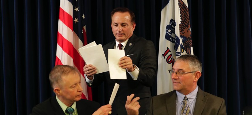 Iowa Sec. of State Paul Pate, center, collects ballots from Iowa electors Alan Braun, of Norwalk, Iowa, left, and Don Kass, of Remsen, Iowa, right, during Iowa's Electoral College vote in 2016.