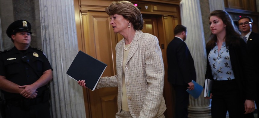 Sen. Lisa Murkowski, R-Alaska, arrives for a vote as the Republican-run Senate rejected a GOP proposal to scuttle President Barack Obama's health care law and give Congress two years to devise a replacement on Wednesday.