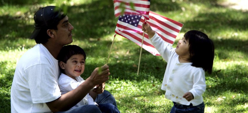 A family relaxes on the sidelines of an immigration protest outside the Capitol in Jackson, Miss. in 2006.