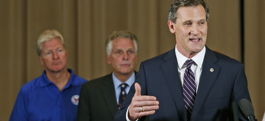 Charlottesville Mayor Mike Signer, right, gestures during a news conference concerning the white nationalist rally and violence as Virginia Gov. Terry McAuliffe, center, and Virginia Secretary of Public safety Brian Moran, left, listen.
