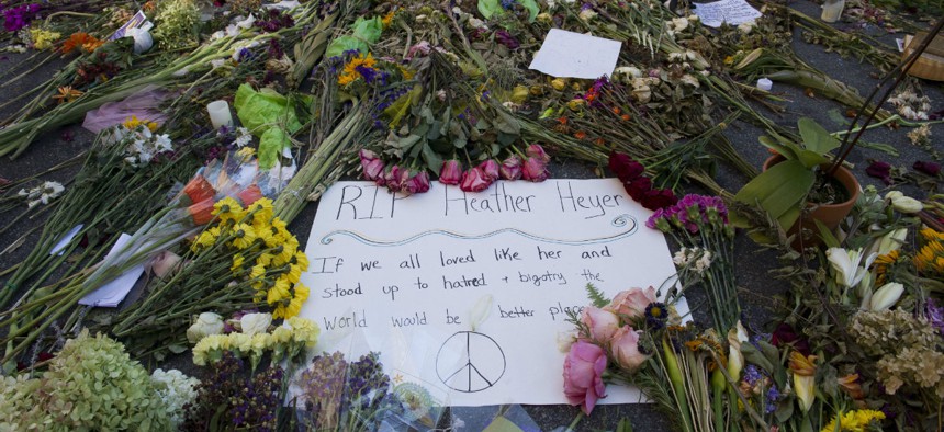 Notes and flowers form a memorial in Charlottesville, Va., on Friday, Aug. 18, 2017 at the site where Heather Heyer was killed. Heyer was struck by a car while protesting a white nationalist rally on Saturday Aug. 12.