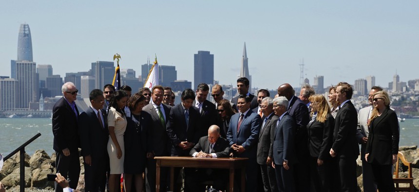 California Gov. Jerry Brown signs a climate bill on July 25 in San Francisco.