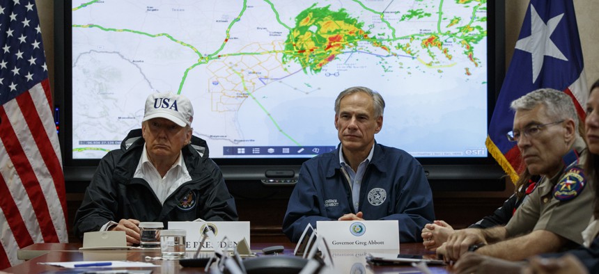 President Donald Trump, accompanied by Texas Gov. Greg Abbott, speaks during a briefing on Harvey relief efforts, Tuesday, Aug. 29, 2017, at the the Texas Department of Public Safety Emergency Operations Center in Austin, Texas.
