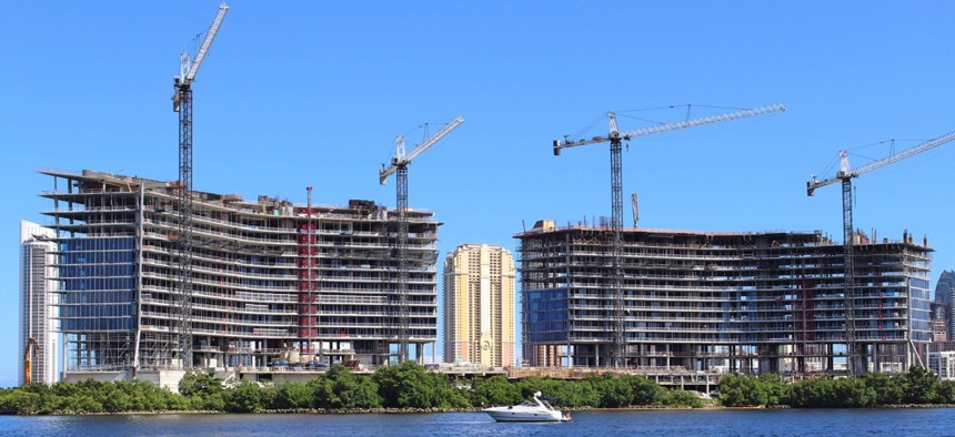 Cranes loom over construction sites in Miami.