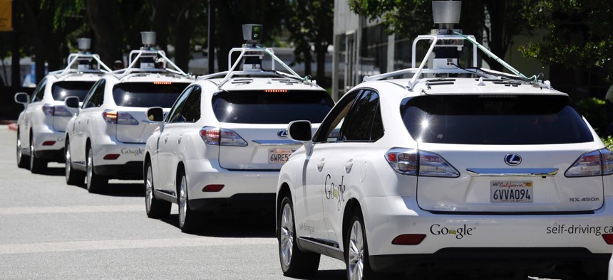 a row of Google self-driving Lexus cars at a Google event outside the Computer History Museum in Mountain View, California.