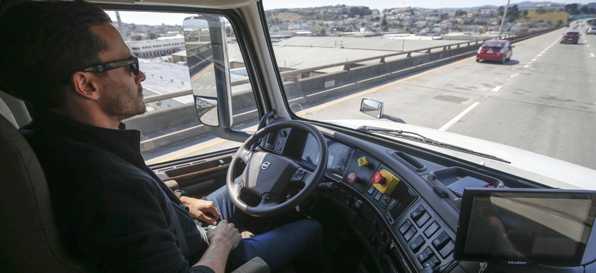 Matt Grigsby, senior program engineer at Otto, takes his hands off the steering wheel of the self-driving, big-rig truck during a demonstration on the highway, on Aug. 18, 2016, in San Francisco. 