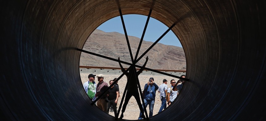 People stand in a metal tube after a test of a Hyperloop One propulsion system in May 2016 in North Las Vegas, Nevada.