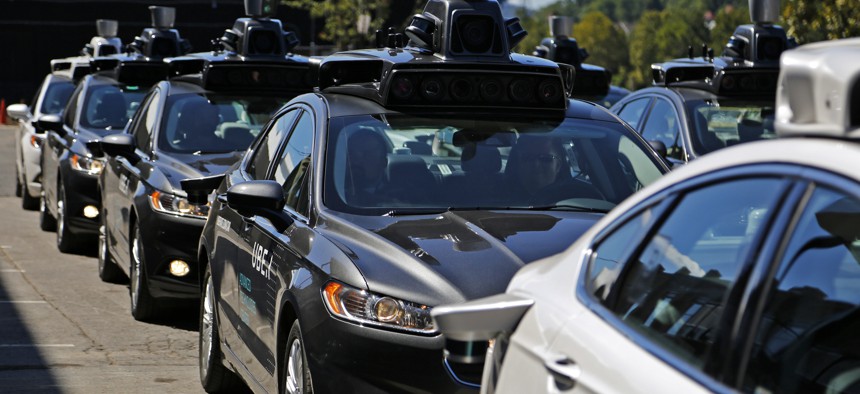In September 2016, a group of self-driving Uber vehicles position themselves to take journalists on rides during a media preview at Uber's Advanced Technologies Center in Pittsburgh.