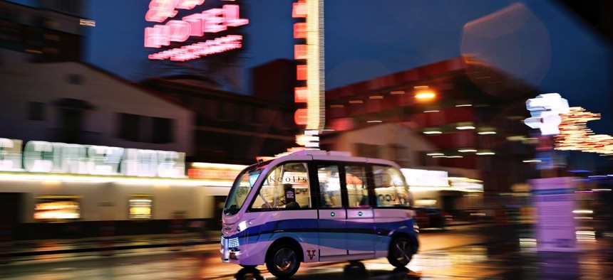 The Navya Arma autonomous vehicle drives down a street in Las Vegas.