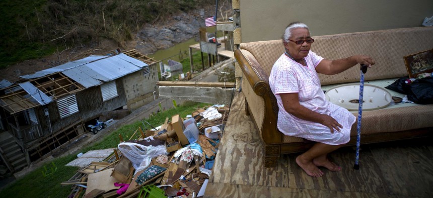 Juana Sortre Vazquez sits on her soaked couch in what remains of her home, destroyed by Hurricane Maria, in the San Lorenza neighborhood of Morovis, Puerto Rico.
