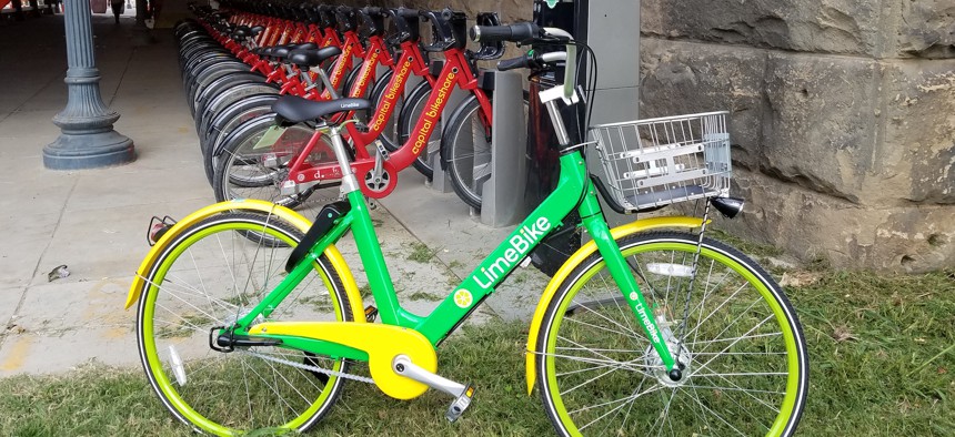 A dockless LimeBike stands next to a Capital Bikeshare docking station near Union Station in Washington, D.C.