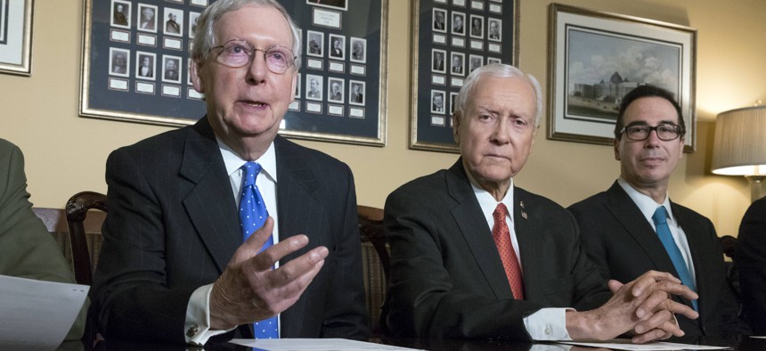 From left, Senate Majority Leader Mitch McConnell, R-Ky., Senate Finance Committee Chairman Orrin Hatch, R-Utah, and Treasury Secretary Steven Mnuchin, make statements to reporters as work gets underway on the Senate's version of the GOP tax reform bill.