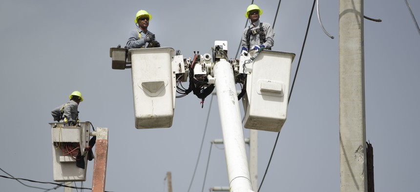 a brigade from the Electric Power Authority repairs distribution lines damaged by Hurricane Maria in the Cantera community of San Juan, Puerto Rico.