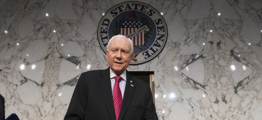 In this Nov. 13, 2017, photo, Senate Finance Committee Chairman Orrin Hatch, R-Utah, arrives as the tax-writing panel begins work on overhauling the nation's tax code.