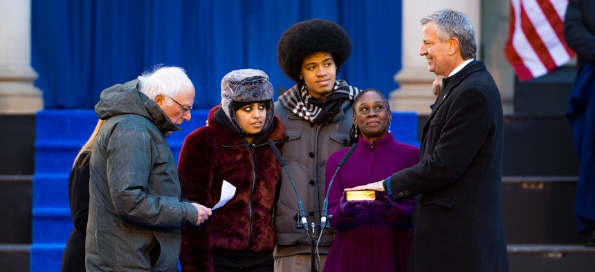 New York City Mayor Bill de Blasio is sworn in by U.S. Sen. Bernie Sanders at the City of New York 2018 inaugural ceremonies on Monday on the steps of City Hall.