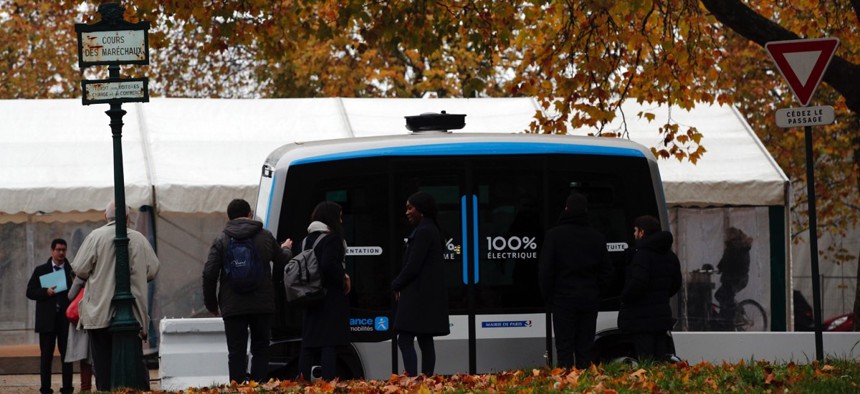 An electric, driverless shuttle produced by EasyMile drives as part of an experiment in Paris, France.