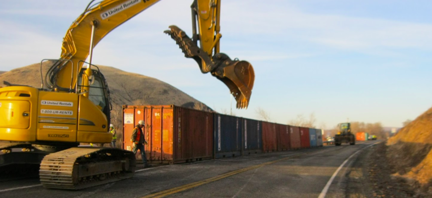 The Washington State Department of Transportation has deployed shipping containers to create a rockfall barrier near the site of a growing fissure on a ridge high above I-82 near Yakima, Wash.