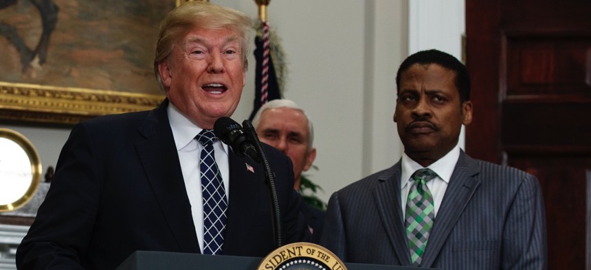 President Trump speaks during an event honoring Martin Luther King Jr. while his nephew, Isaac Newton Farris Jr., listens on Friday at the White House.