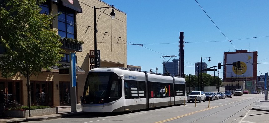 A streetcar vehicle moves along Main Street in downtown Kansas City.