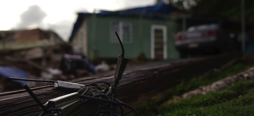 A light pole knocked down by the winds of Hurricane Maria remains on the ground in front of the house of the Oliveras González family in Morovis, Puerto Rico.
