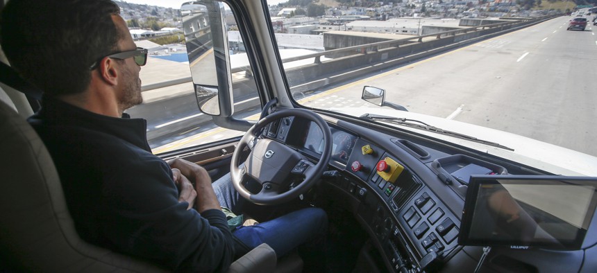 Matt Grigsby, senior program engineer at Otto, takes his hands off the steering wheel of the self-driving, big-rig truck during a demonstration on the highway, Thursday, Aug. 18, 2016, in San Francisco.
