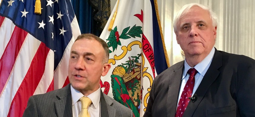 Dr. Michael Brumage, left, is joined by West Virginia Gov. Jim Justice, right, at a news conference Monday, Feb. 5, 2018, at the Capitol in Charleston, West Virginia.