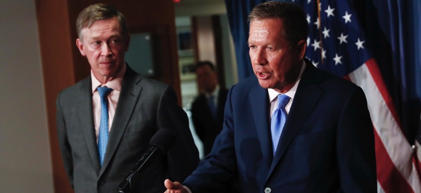 Ohio Gov. John Kasich, right, and Colorado Gov. John Hickenlooper introduce the first version of their bipartisan health blueprint in the summer of 2017.