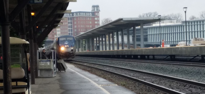 An Amtrak train pulls into the current train station, at left, which sits adjacent to the new Raleigh Union Station complex, at right.