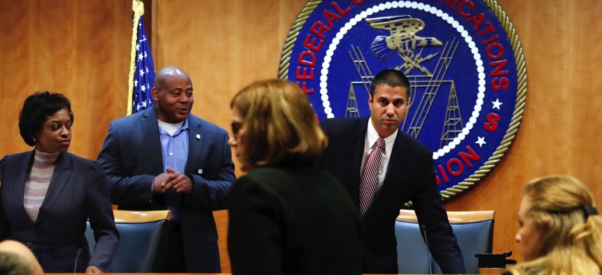 Federal Communications Commission Chairman Ajit Pai, right, and Commissioner Mignon Clyburn, far left, on Dec. 14 in Washington, D.C.