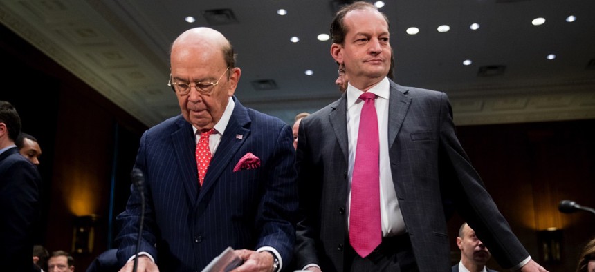 Commerce Secretary Wilbur Ross, center left, and Labor Secretary Alex Acosta, right, arrive before a Senate Committee on Commerce, Science, & Transportation hearing on infrastructure Wednesday in Washington, D.C.