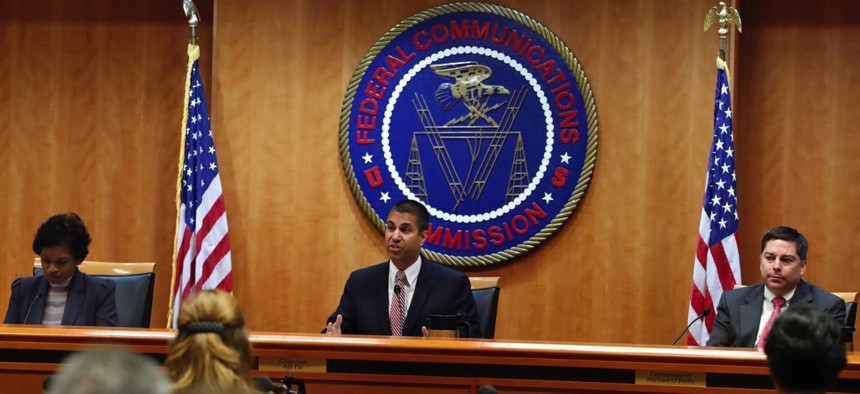 Federal Communications Commission Chairmnnouan Ajit Pai, center, next to Commissioner Mignon Clyburn, left, and Commissioner Michael O'Rielly in December in Washington, D.C.