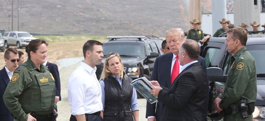 President Donald Trump reviews border wall prototypes in San Diego on March 13.