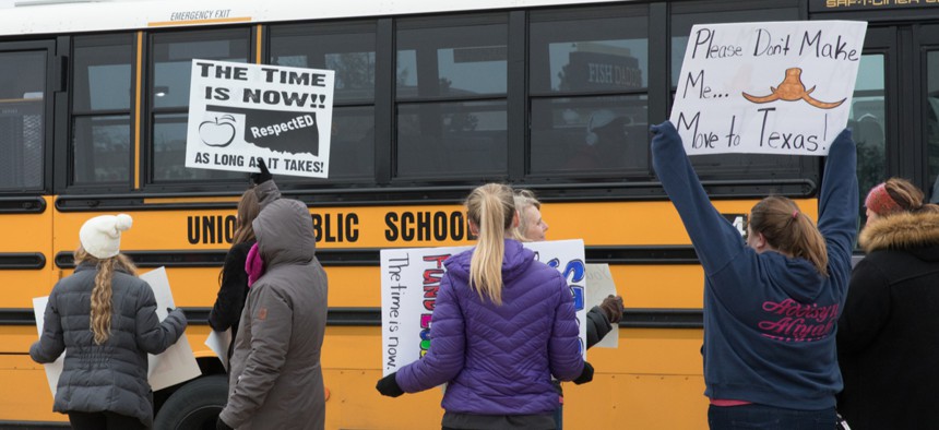 A school bus passes a group of striking teachers in Tulsa, Oklahoma on April 2.