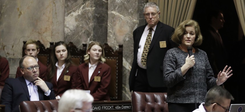 Washington state Sen. Christine Rolfes, right, speaks on the Senate floor during debate over the supplemental budget, Thursday, March 8, 2018 at the Washington State Capitol in Olympia.