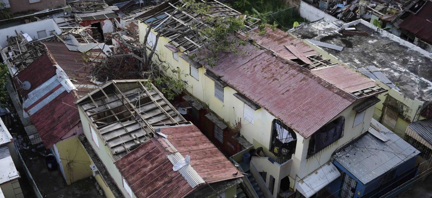 In this Nov. 15, 2017 photo, some roofs damaged by the whip of Hurricane Maria are shown still exposed to rainy weather conditions, in San Juan, Puerto Rico.