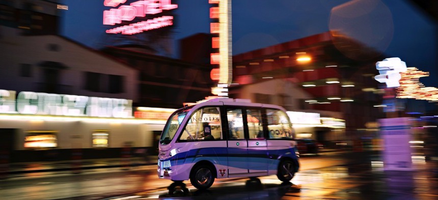 A Navya Arma autonomous vehicle drives down a street in Las Vegas. The driverless electric shuttle began carrying passengers as part of a 2017 pilot.