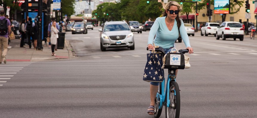 A woman rides a Divvy bike in Chicago. The city hopes dockless bike sharing will complement the existing system and other mobility options.