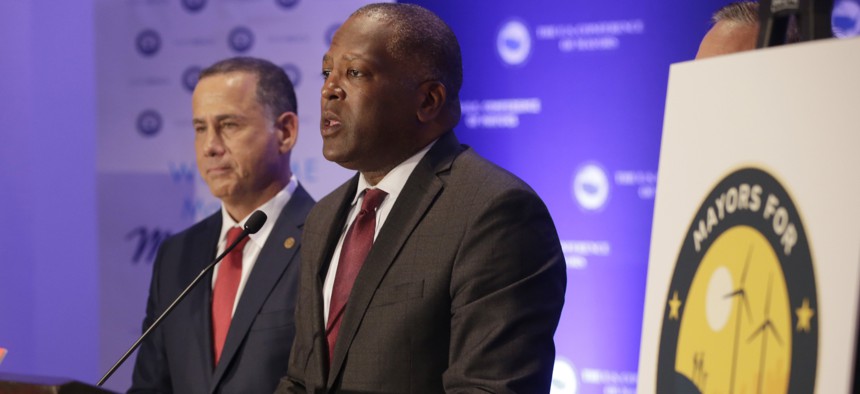 Steve Benjamin, mayor of Columbia, S.C, right, speaks during a news conference with Miami Beach Mayor Philip Levine, left, at the annual U.S. Conference of Mayors meeting, Monday, June 26, 2017, in Miami Beach, Fla.