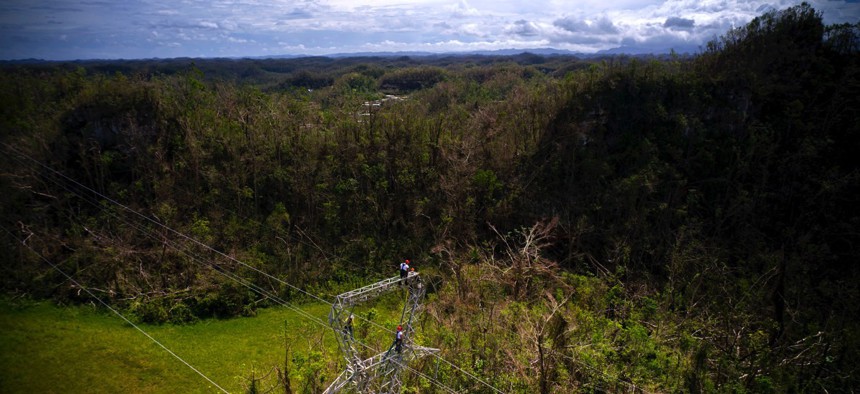 Electrical lineman work on transmission towers in October in Barceloneta, Puerto Rico.