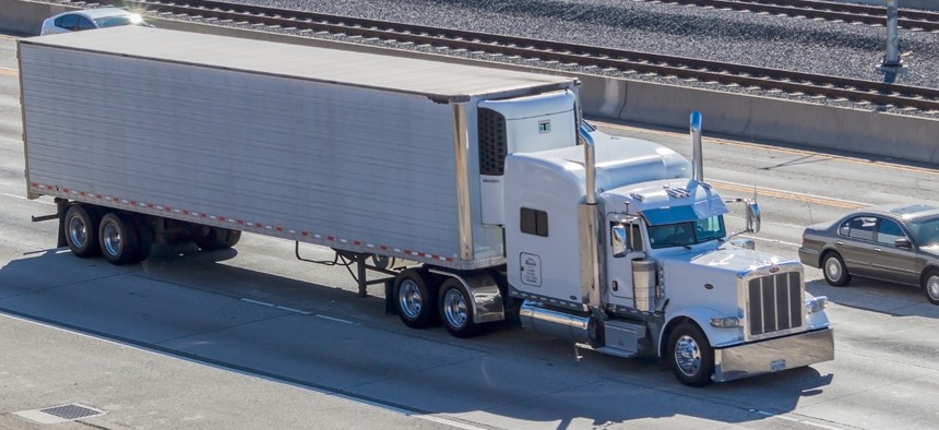 A semi truck travels on a Southern California freeway.