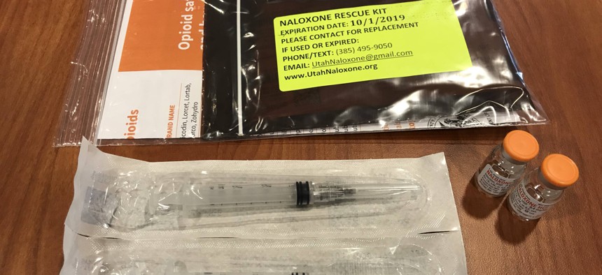 Each naloxone kit contains two syringes of the injectable overdose antidote, along with an information card.