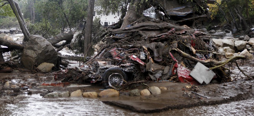 A car and debris smashed against a tree along Hot Springs Road in Montecito, Calif. Heavy rain brought flash flooding and mudslides to the area in Montecito, Calif. on Tuesday, January 9, 2018.