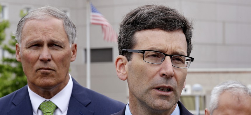 Washington state Attorney General Bob Ferguson, right, speaks as Gov. Jay Inslee looks on at a news conference announcing a lawsuit against the Trump administration over a policy of separating immigrant families illegally entering the United States.