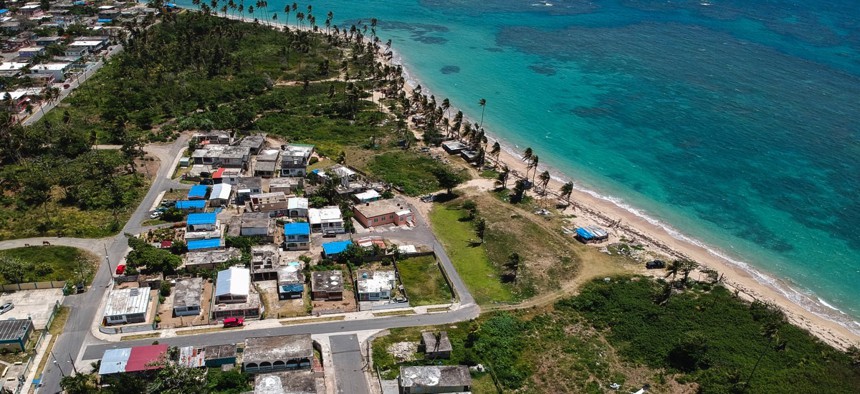 The Viequez neighborhood east of San Juan, Puerto Rico. Thousands of people across the island are still living in damaged homes, protected by blue plastic tarps, nine months after Hurricane Maria hit.