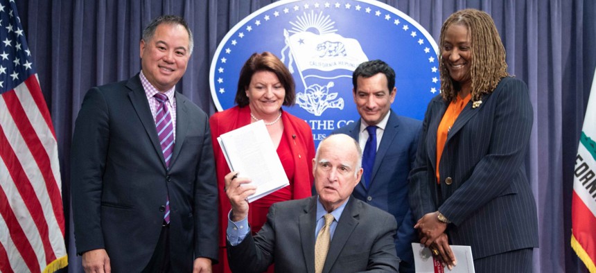 California Gov. Jerry Brown, seated, with Assemblymember Phil Ting, Senate President Pro Tem Toni Atkins, Assembly Speaker Anthony Rendon and Sen. Holly J. Mitchell.