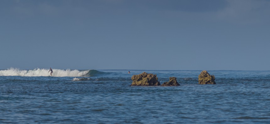 Honolulu, Hawaii, USA. June 14, 2018. A surfer enjoys a wave at Ala Moana Bowls.