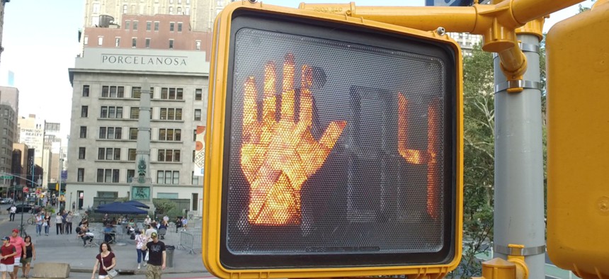 Crosswalk countdown signal in New York CIty illuminated to stop people for traffic to pass through intersection. 